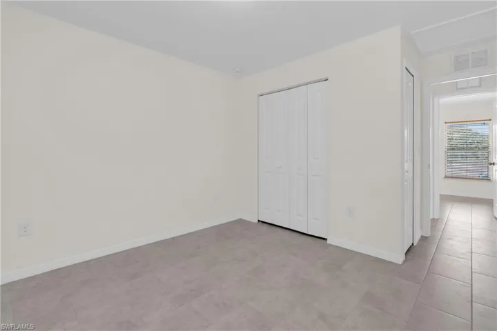 bedroom with baseboards and a closet