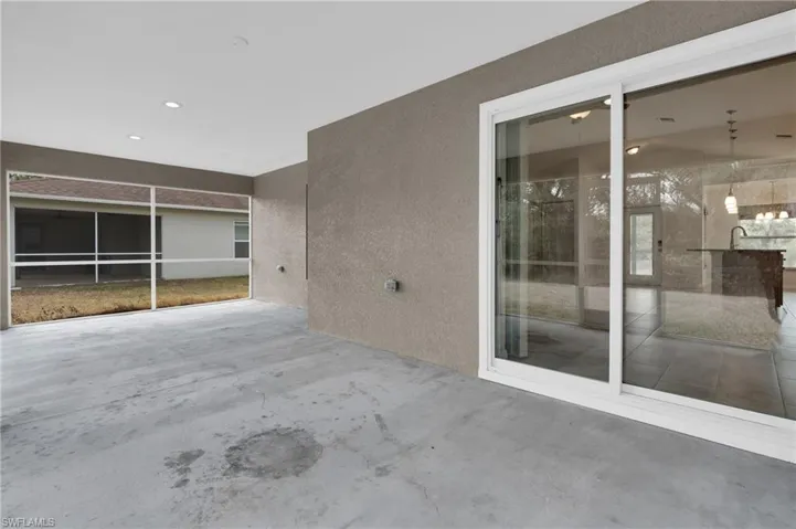 View of patio with a sunroom