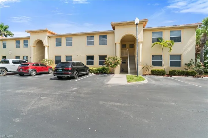 Building exterior. Black SUV is parked at spot #125 which conveniently belongs to this unit. Stairwell on right leads you right to front door!