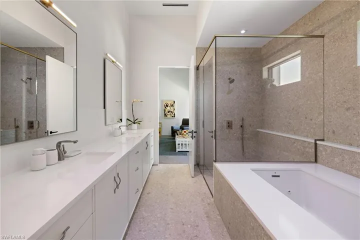 Bathroom featuring vanity and plus walk in shower