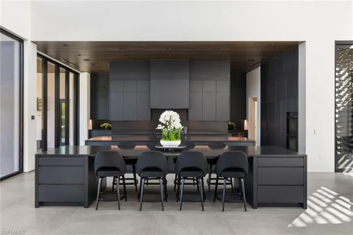 Kitchen featuring a breakfast bar area, gray cabinets, and wooden ceiling