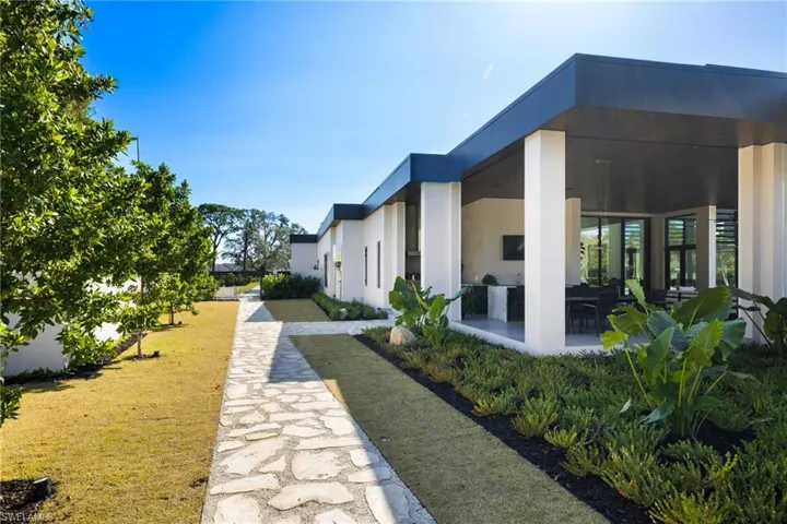View of home's community with a lawn