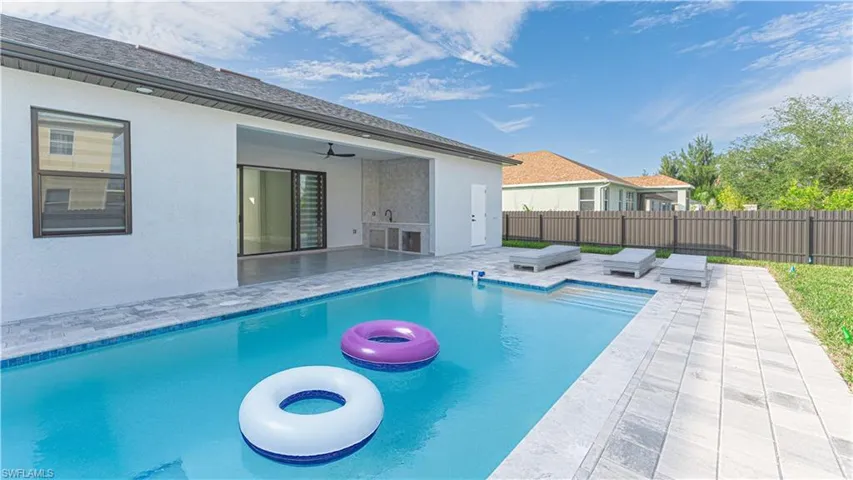 View of pool featuring ceiling fan, a jacuzzi, and a patio