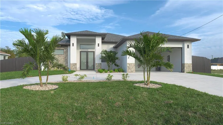 View of front facade featuring a garage, a front lawn, and french doors