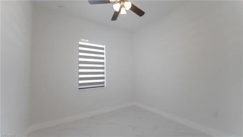 Unfurnished room featuring ceiling fan