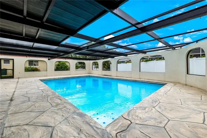 Swimming pool featuring a patio area and a lanai