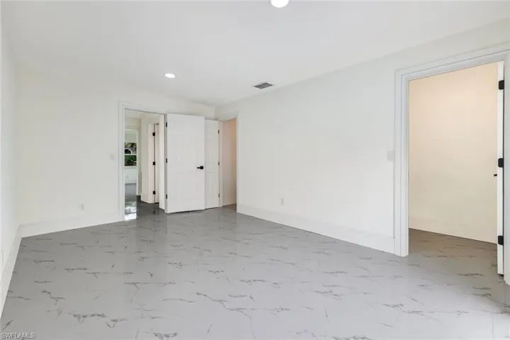 Empty room with recessed lighting and light marble finish flooring