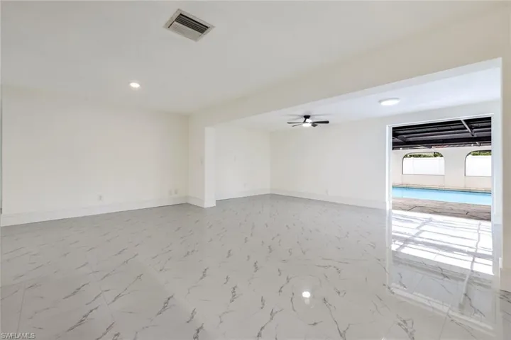 Empty room with light marble finish floors, recessed lighting, and ceiling fan
