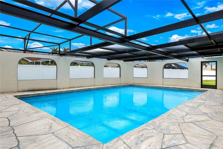 Swimming pool with a lanai, a patio area, and a sunroom