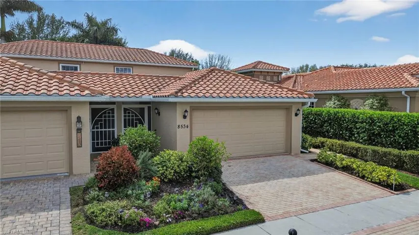 Mediterranean / spanish-style home featuring stucco siding, a tile roof, a garage, and driveway