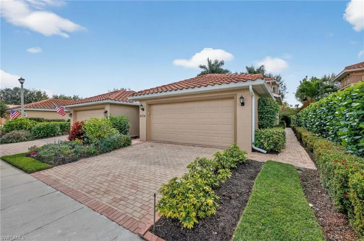Mediterranean / spanish-style house featuring stucco siding, decorative driveway, a tile roof, and an attached garage
