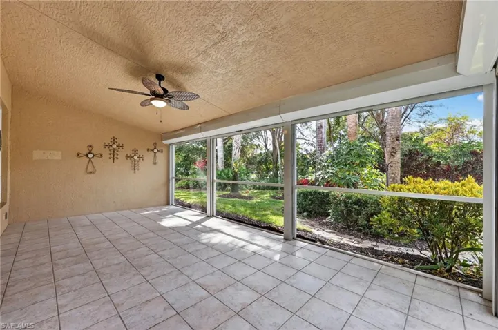 Unfurnished sunroom with a ceiling fan