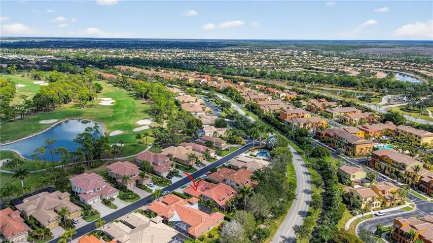 Aerial perspective of area with a large body of water and a golf course