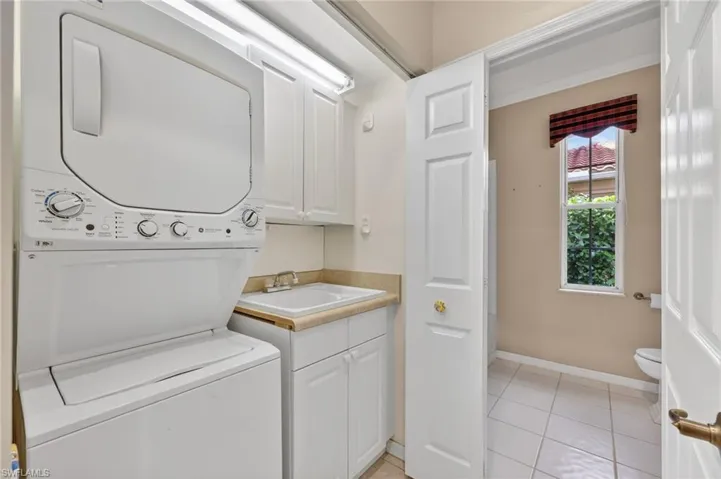 Laundry area featuring stacked washer and dryer