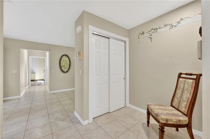 Corridor to Pantry and storage space with and light tile floors