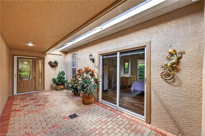 Courtyard to property featuring stucco siding and a patio