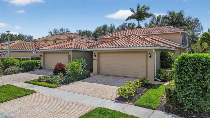 Mediterranean / spanish house featuring stucco siding, a garage, decorative driveway, and a tile roof