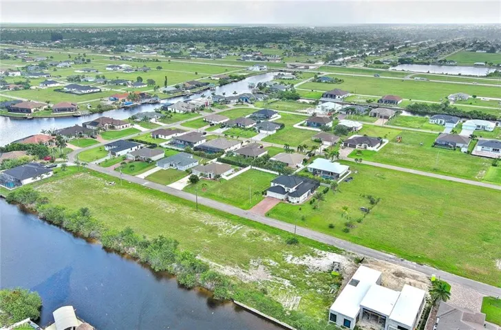 Aerial perspective of suburban area with a large body of water