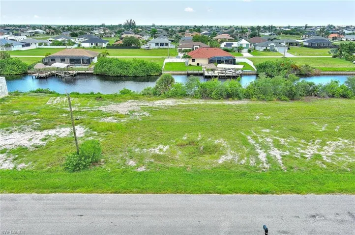 Aerial view of residential area featuring a nearby body of water