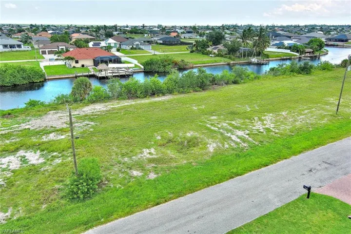 Aerial perspective of suburban area featuring a large body of water