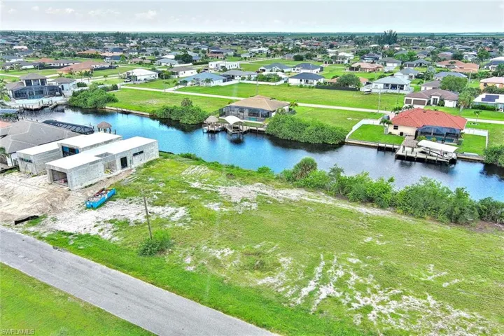 Aerial perspective of suburban area featuring a large body of water