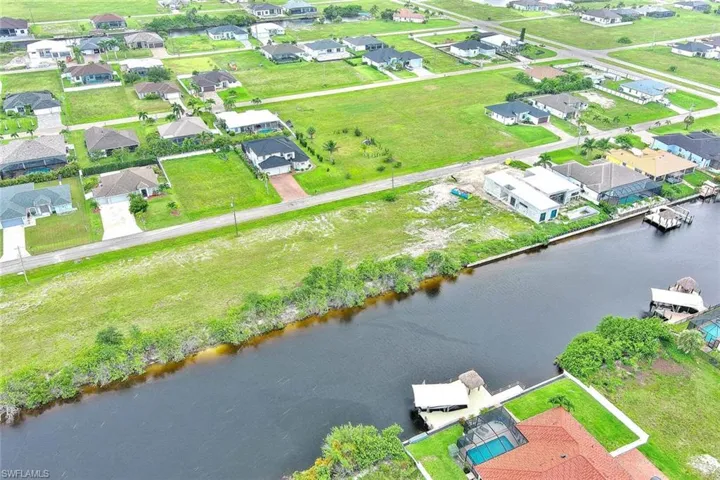 Aerial perspective of suburban area featuring a large body of water
