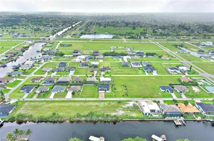View of property location with a nearby body of water and nearby suburban area