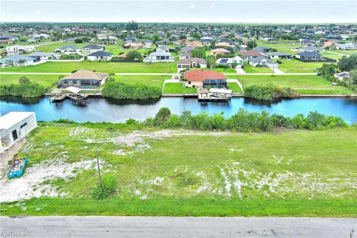 Aerial perspective of suburban area with a large body of water