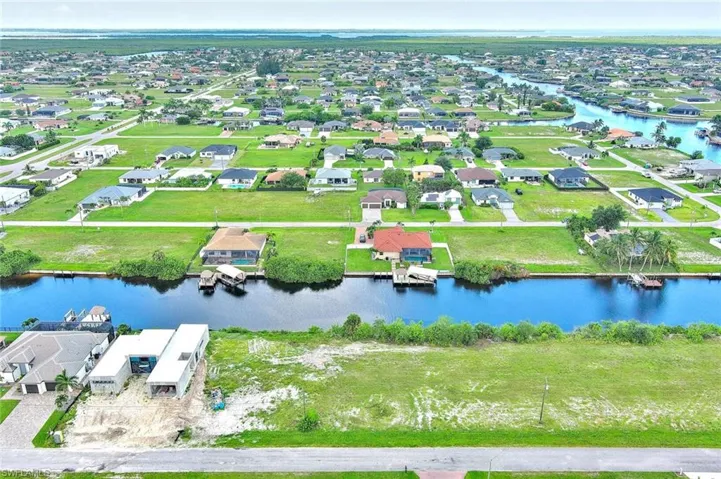 Aerial view of residential area featuring a large body of water