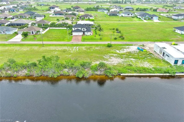 Aerial perspective of suburban area featuring a large body of water