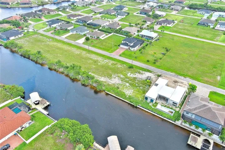 Aerial view of residential area featuring a large body of water