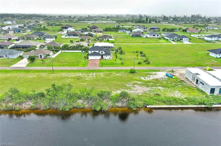 Aerial view of residential area featuring a large body of water