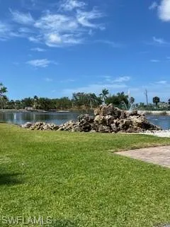 View of green lawn featuring a water view