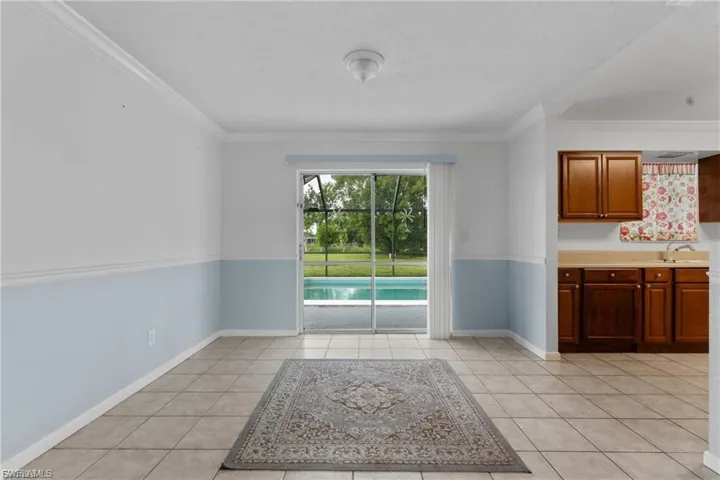 Unfurnished dining area with ornamental molding and light tile patterned floors