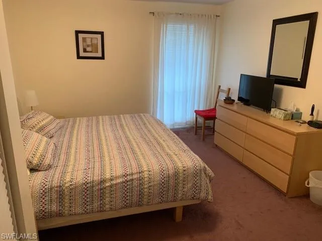 Bedroom with dark carpet