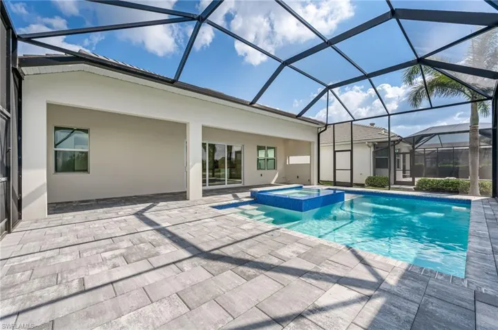 View of swimming pool featuring a lanai, a patio, and a pool with connected hot tub