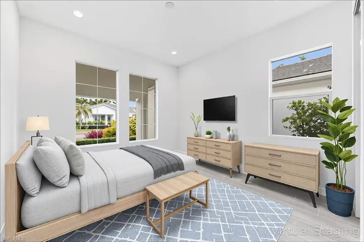 Bedroom featuring baseboards, wood finished floors, and recessed lighting