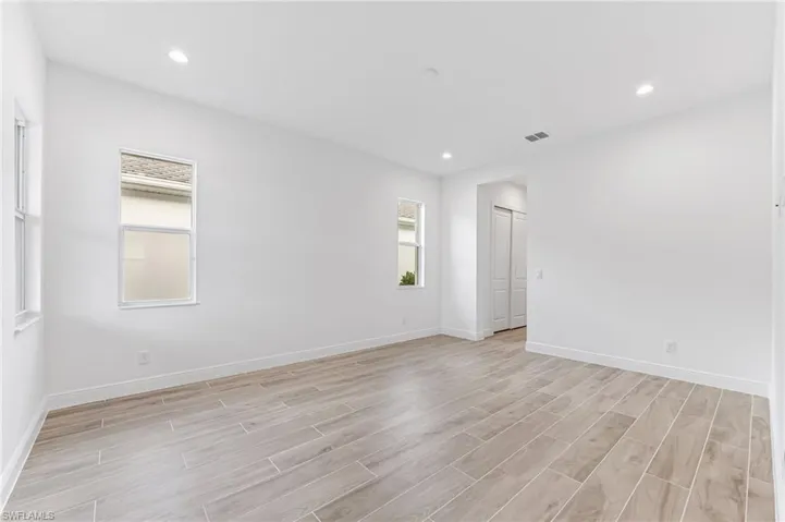 Spare room with recessed lighting, light wood-style floors, and baseboards