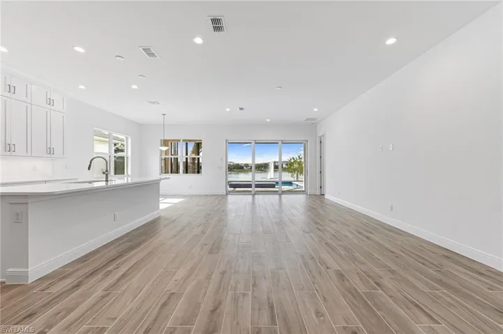 Unfurnished living room featuring visible vents, recessed lighting, and light wood-style floors