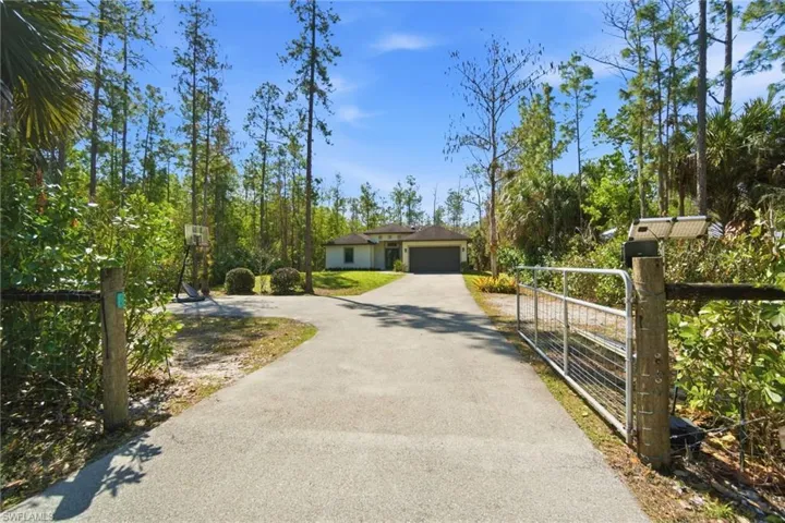 Fenced yard with electronic entry gate & gorgeous screened-in lanai with new pavers to enjoy the nature view.
