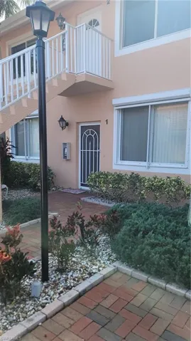 Doorway to property featuring a balcony and stucco siding