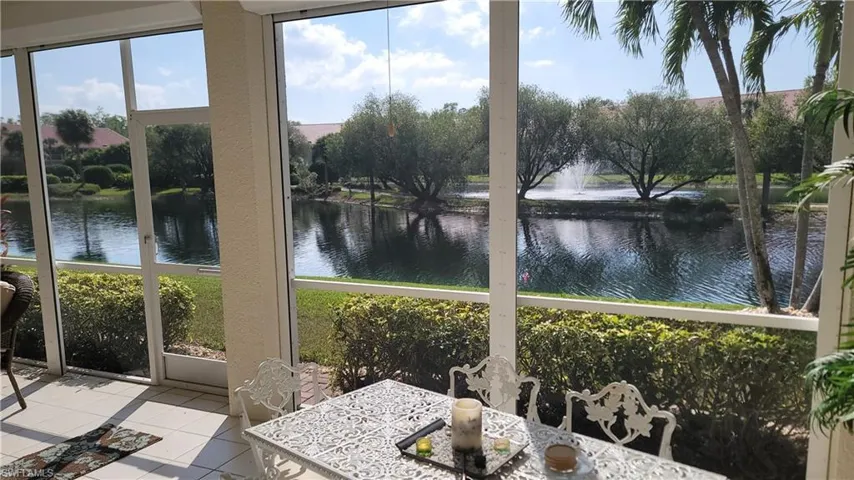 Sunroom featuring a water view and tile patterned flooring