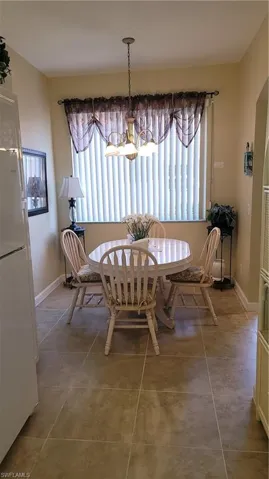 Tiled dining space with an inviting chandelier
