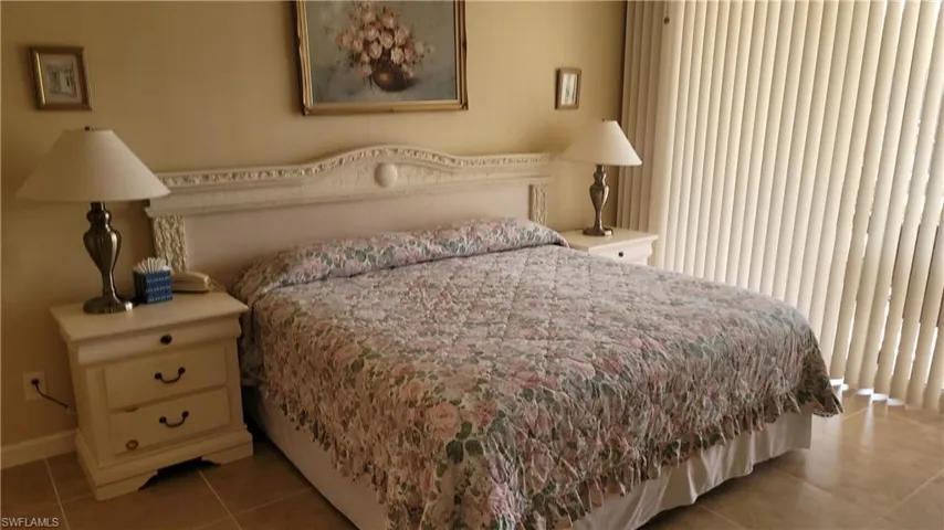 Bedroom with light tile patterned floors and baseboards