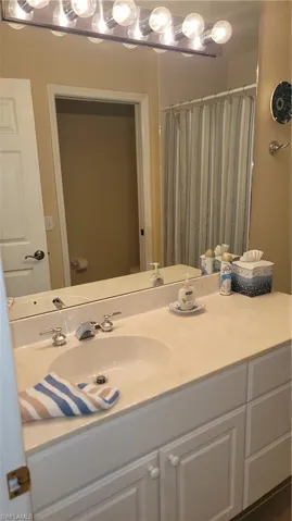 Full bath featuring vanity and a shower with shower curtain