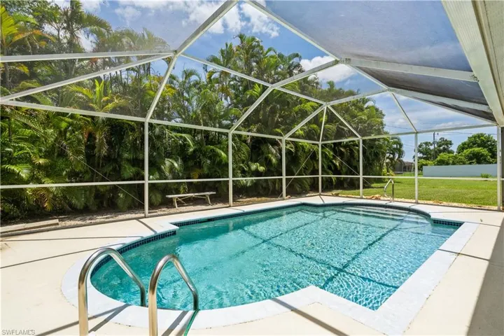 Large pool with mansard screen enclosure