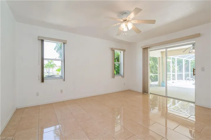 Owner's suite with sliders to lanai/pool area
