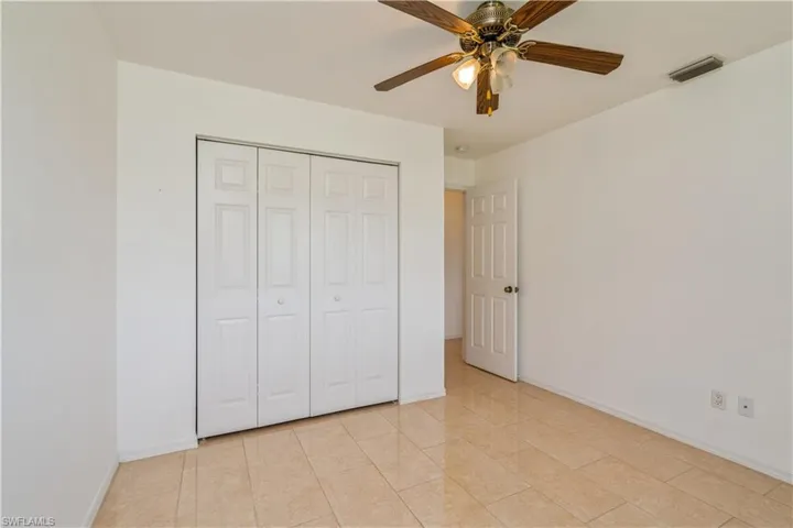 Guest bedroom with tile floors and ceiling fan