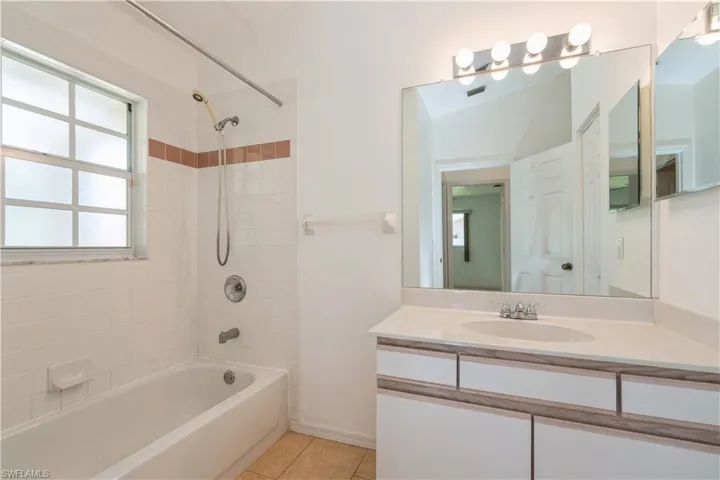 Guest bath with combination shower and tub.