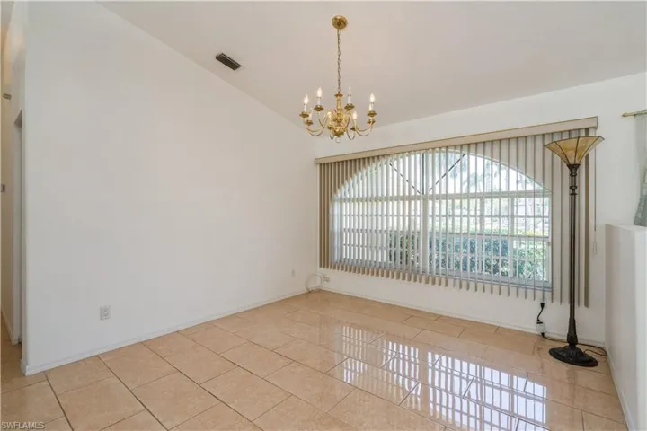 Formal dining room is light and bright with arch window